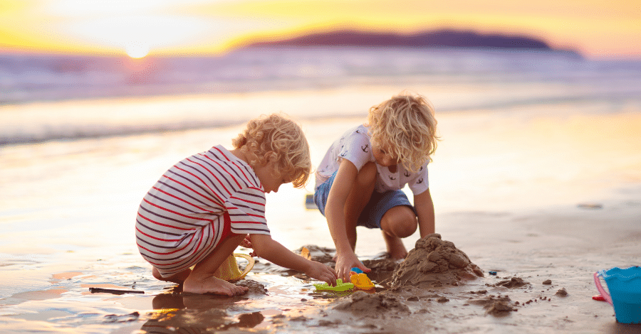 Blonde kids playing on the beach