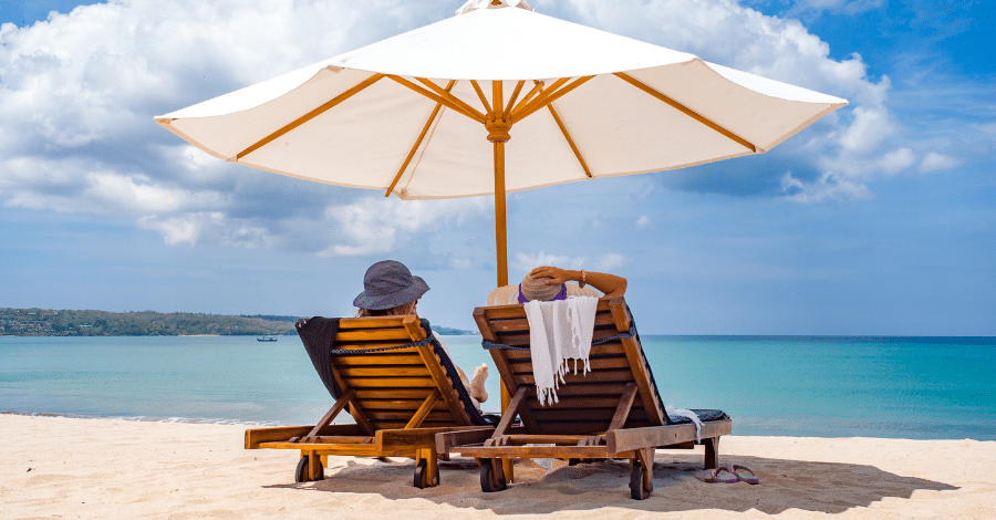 Couple at the beach under umbrella